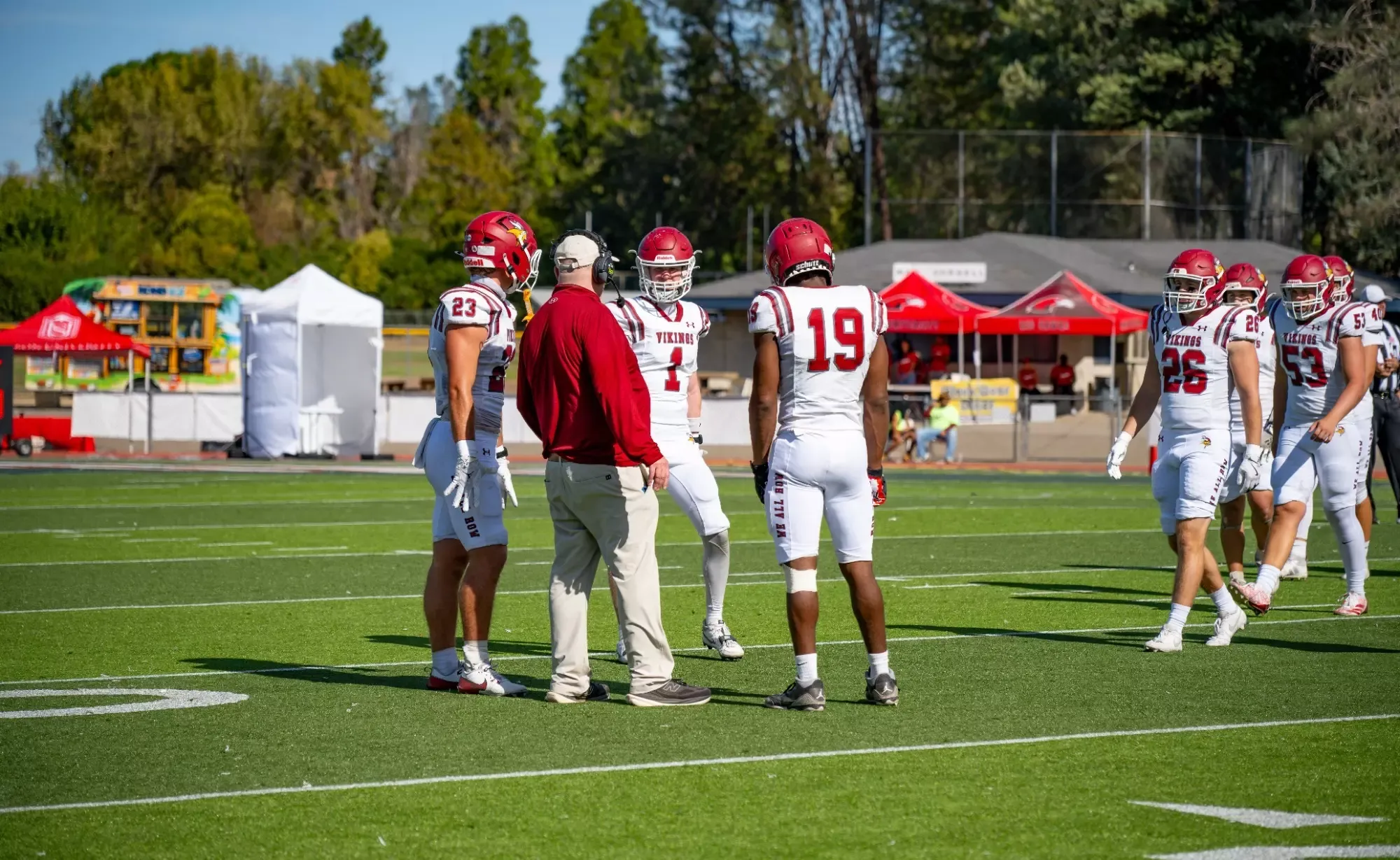 Pre-game story FB vs Rocky Mountain 2026- Players huddle around Coach Mac to discuss the current gameplay. 