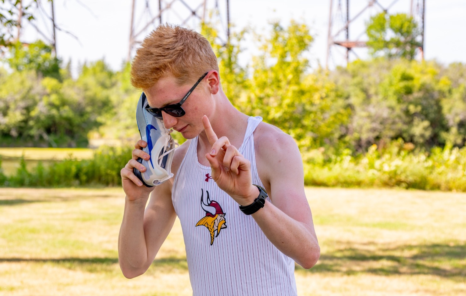 Jimmie Invite Recap 2026- Story Pic, Kole Albers pretends to use shoe as a phone during XC media day.