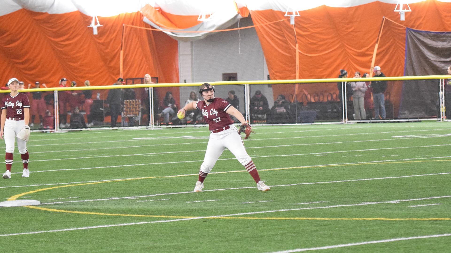 Softball at Jamestown dome tournament, throw from outfield.