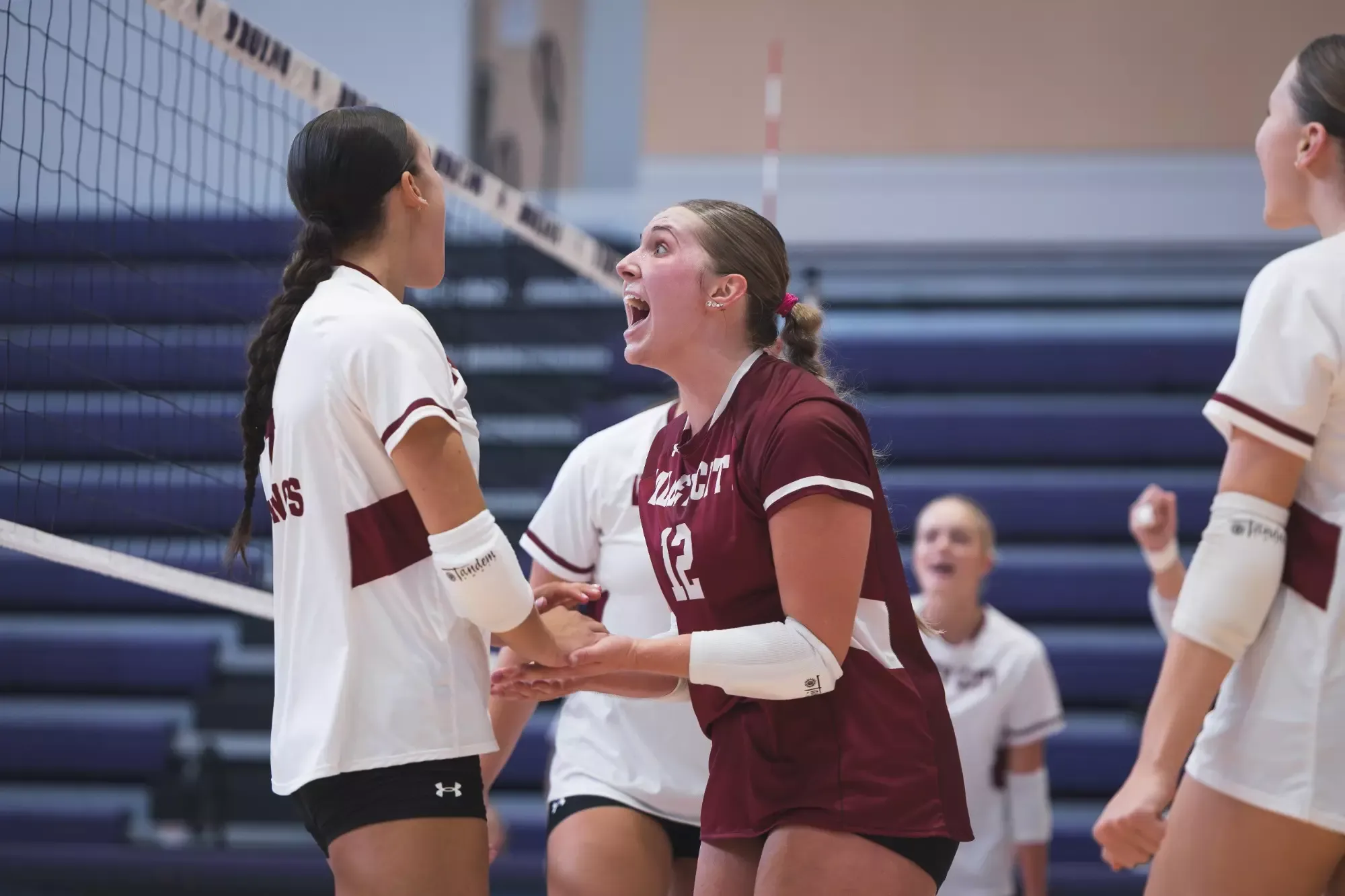 VCSU players celebrate together after winning a point.