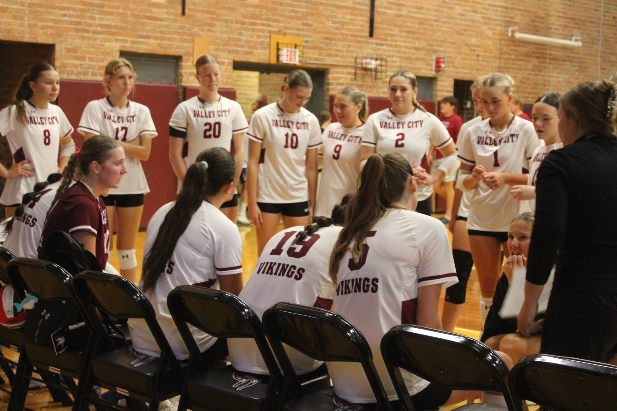 VB story- Rocky Mountain College Pic, VCSU Volleyball discusses game play during timeout.