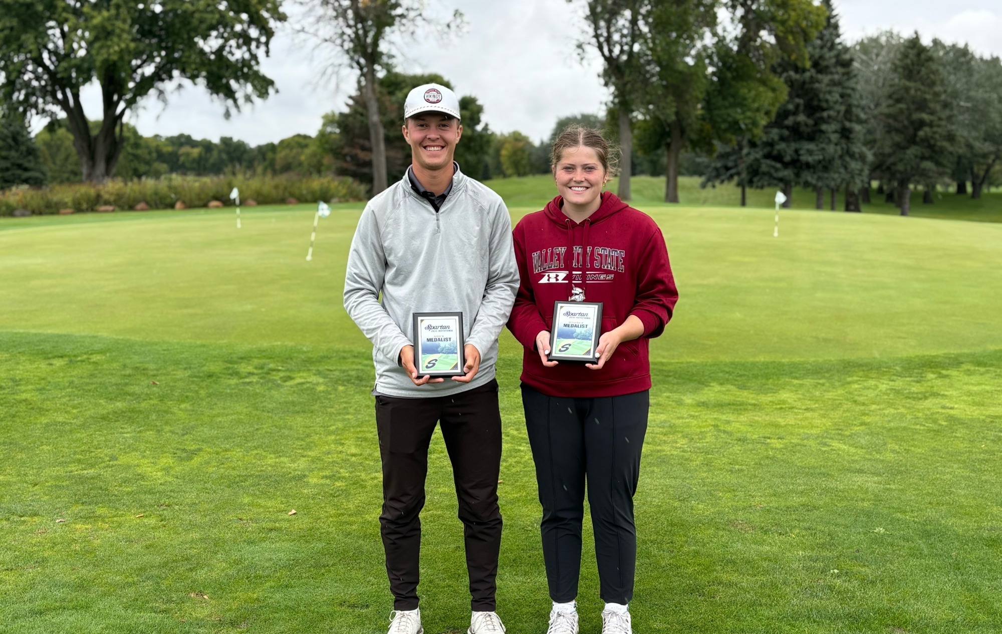 Spartan Invitational- Golf 2026: Sadie Neustel and Owen Haase pose together with their awards.