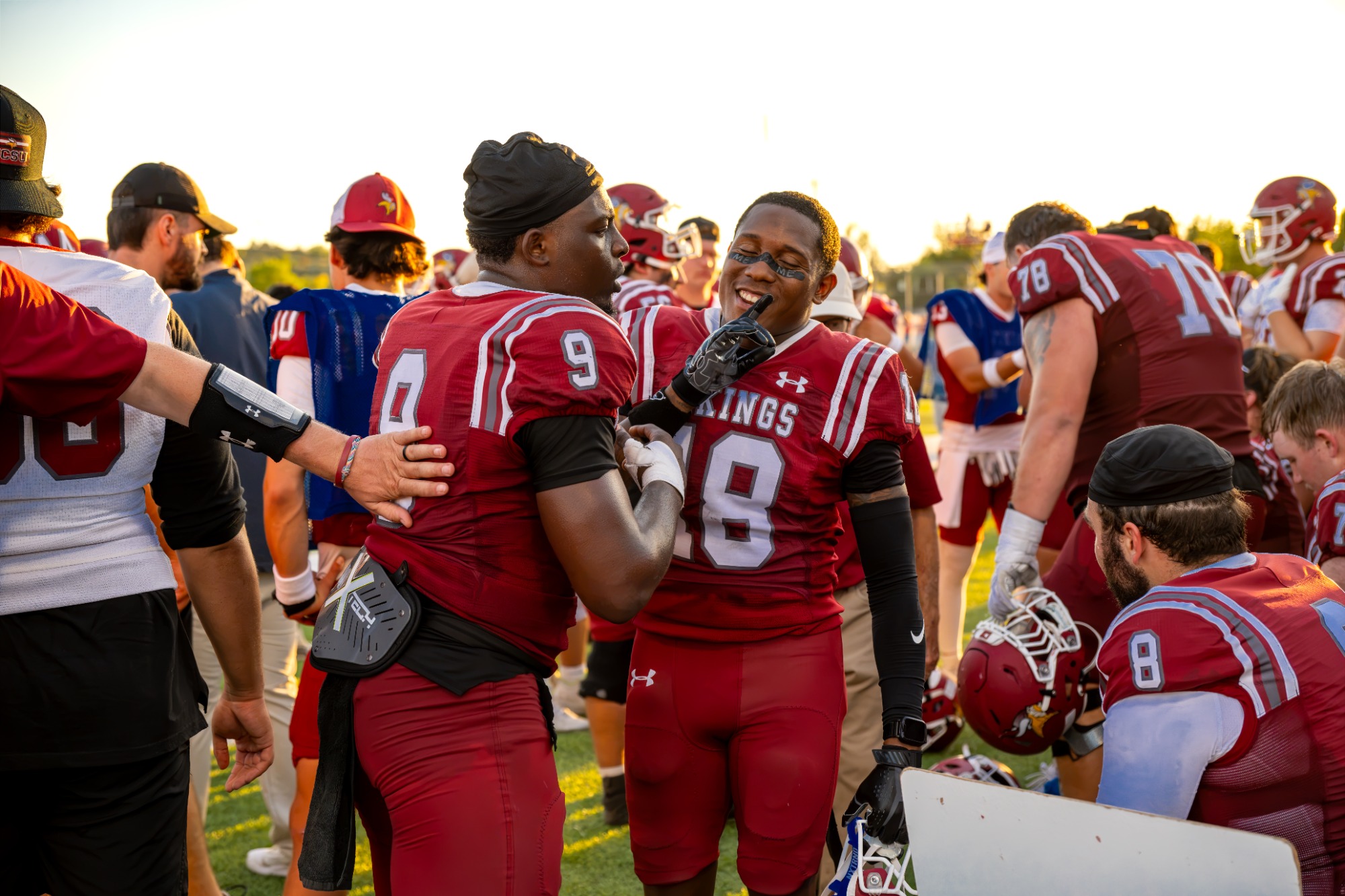 VCSU football players Exavian Westbrook and Laggarius Marshell on the sideline.