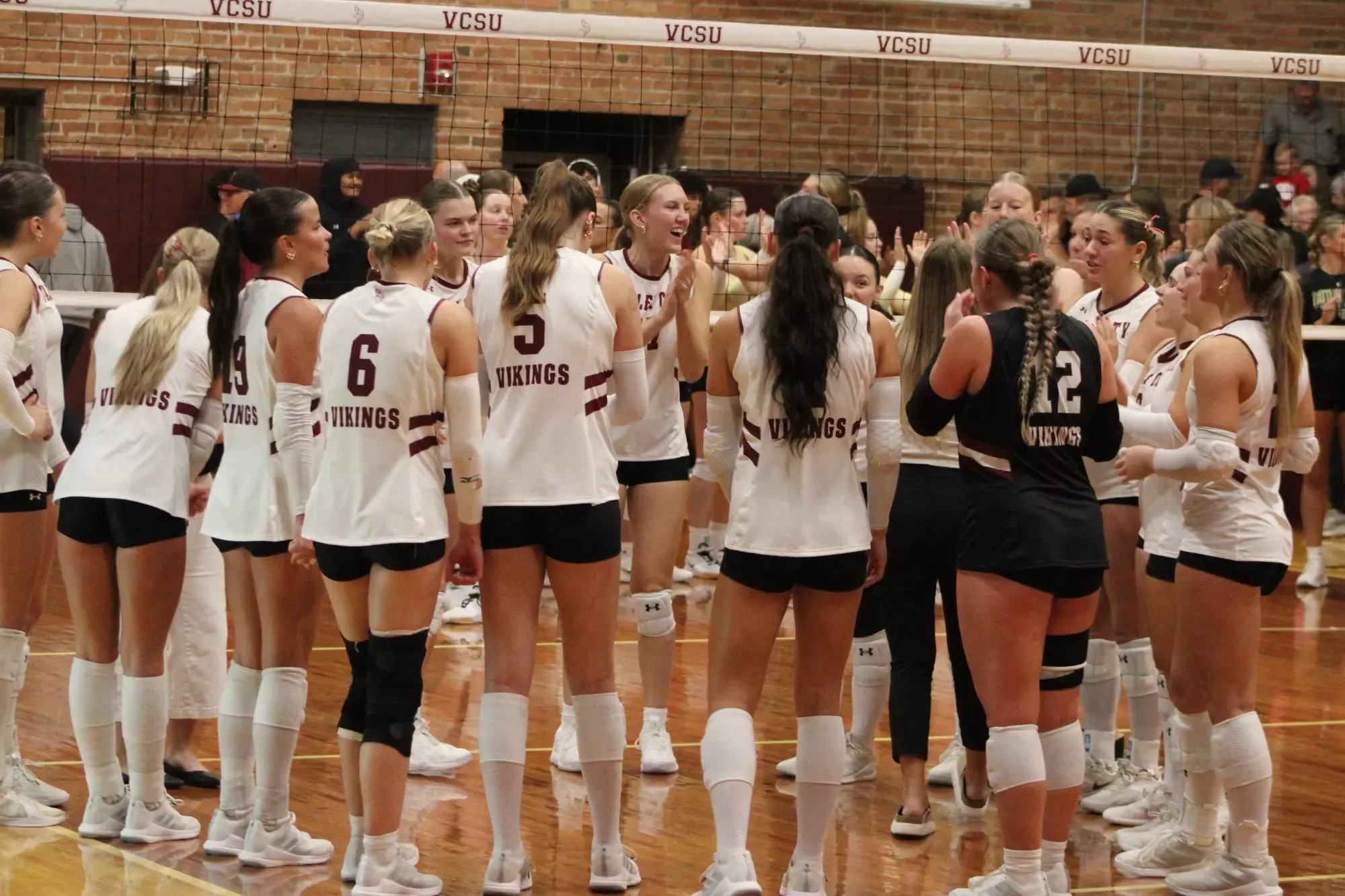 Preview Story Pic- VB vs. Dak State/Bellevue- VCSU Volleyball gathers at the net to celebrate their win over Rocky Mountain. 