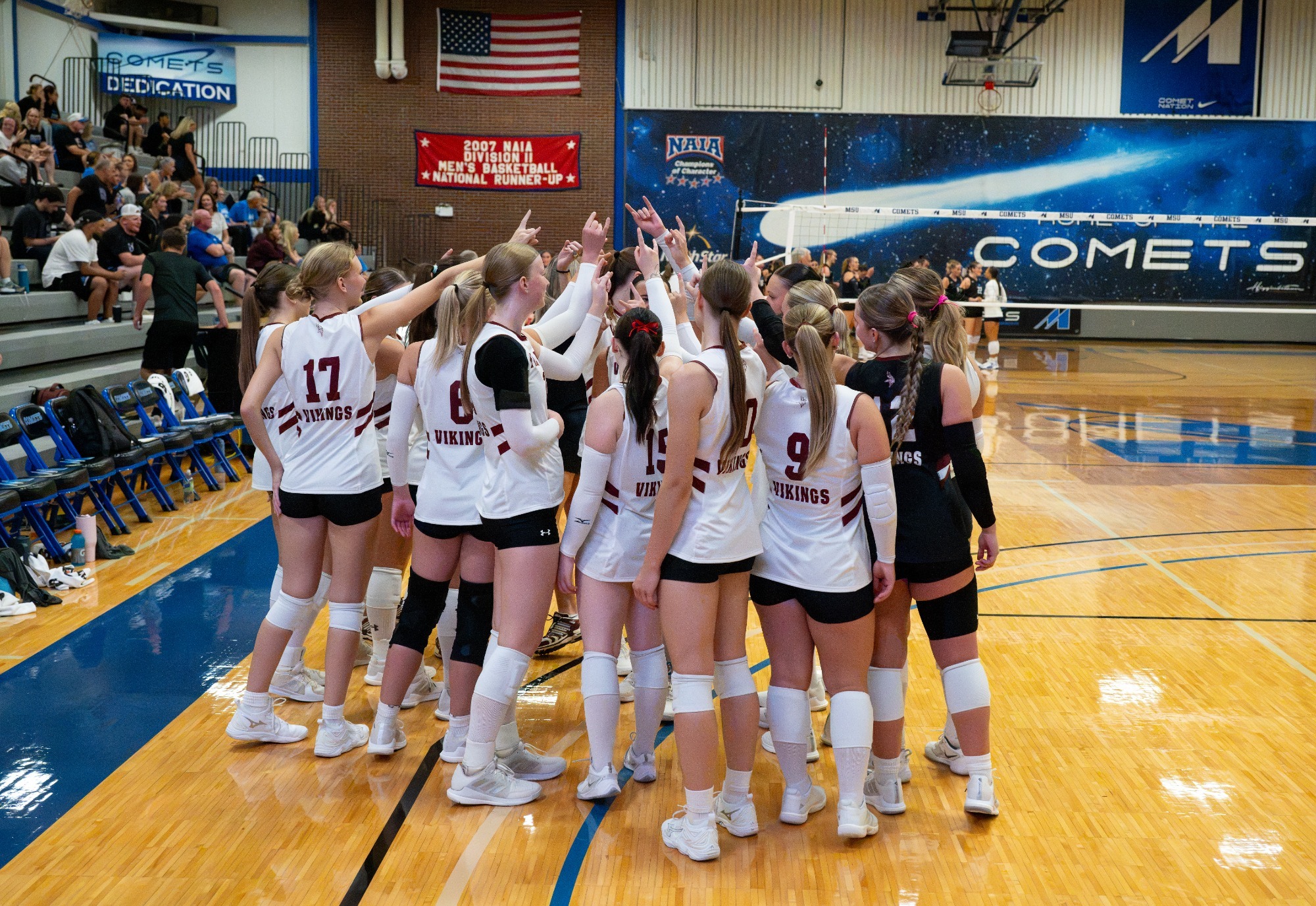Team Breakdown- Vikings gather in the huddle to breakdown as a team before starting the volleyball match. 