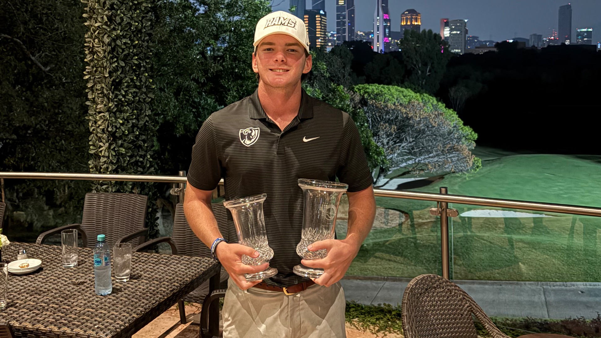 Carson Looney holding trophies after Monterrey win