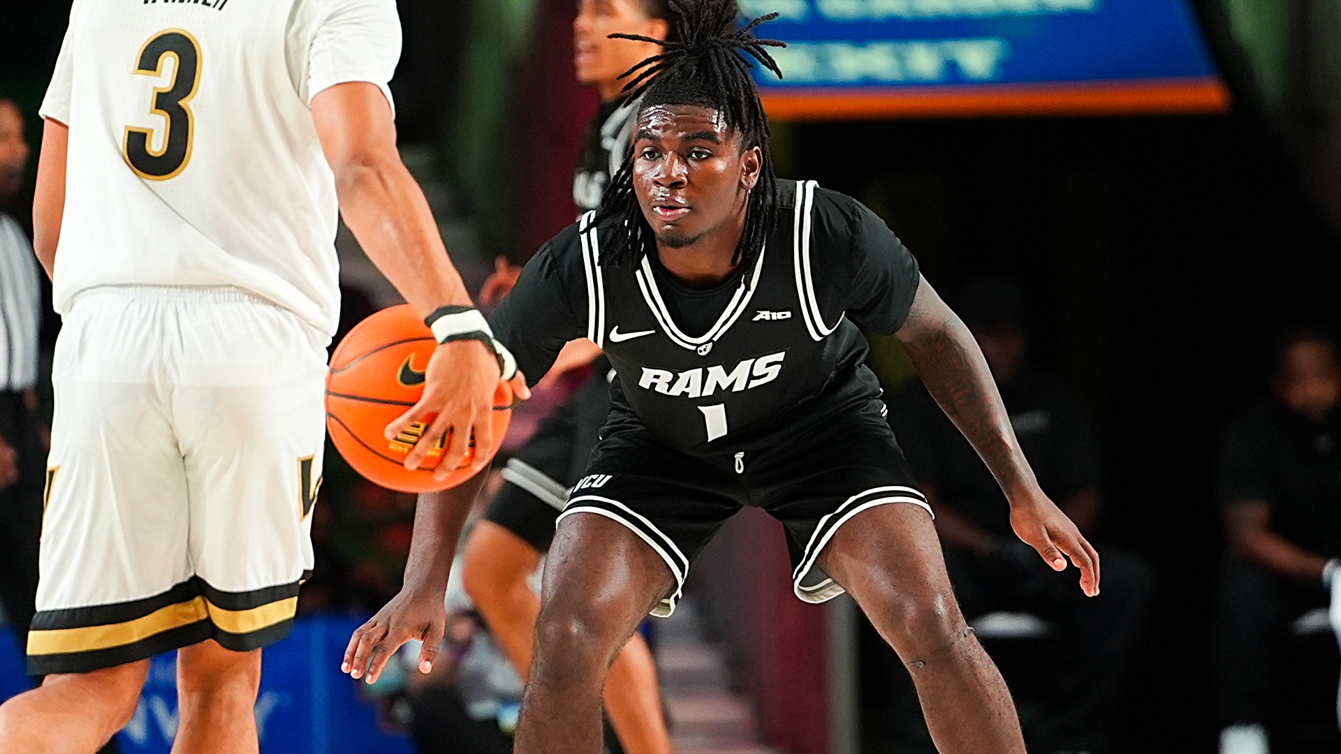 Nyk Lewis guarding player against Vanderbilt