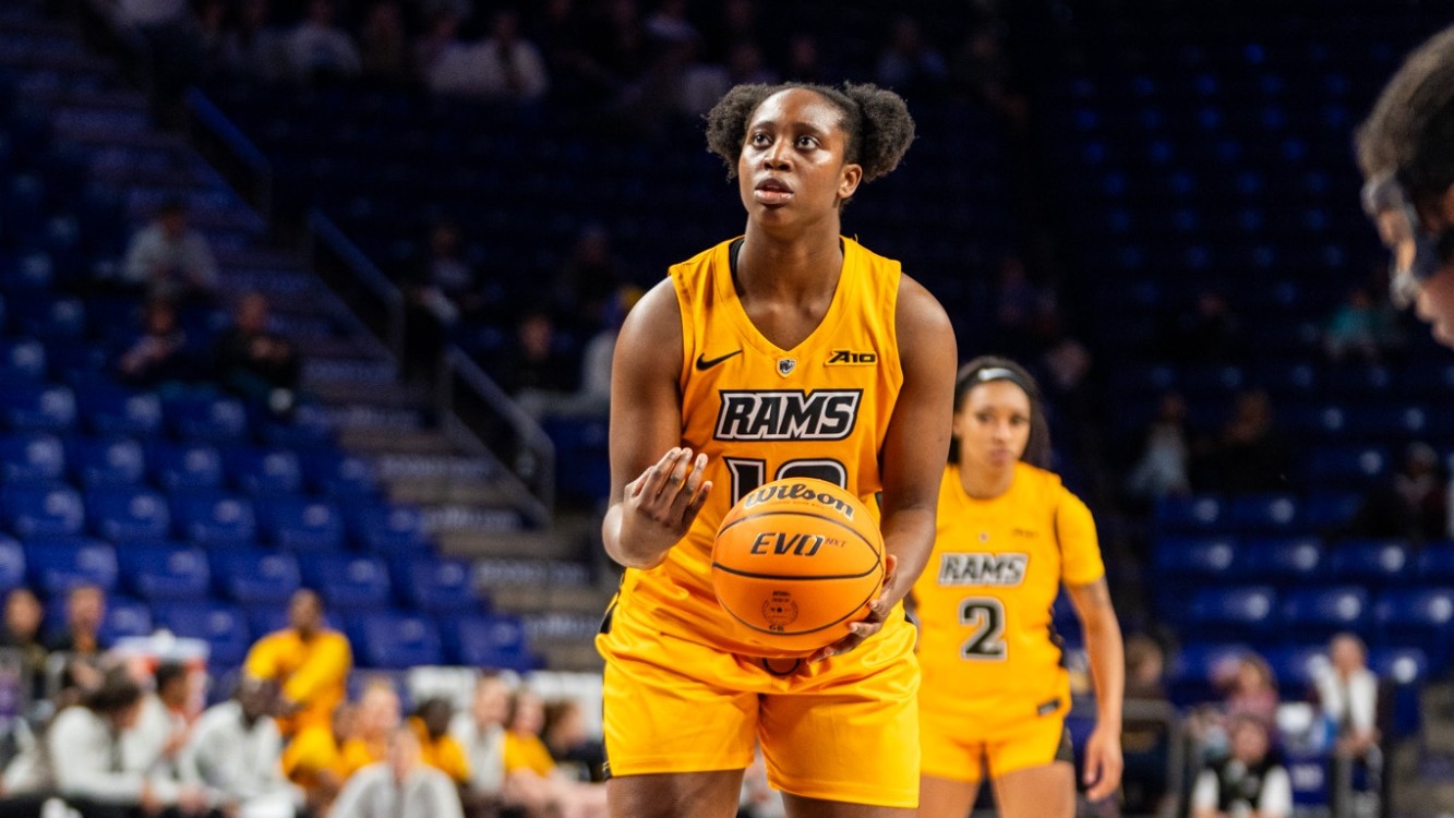 Patricia Augustin of VCU wearing a gold #12 jersey shoots a free throw in a game at JMU