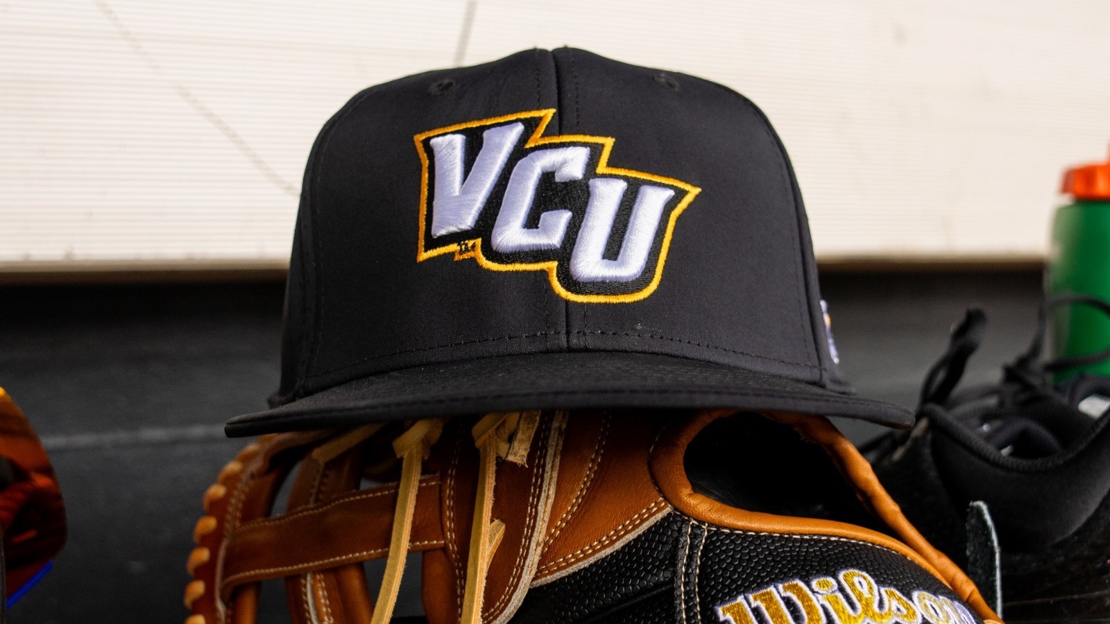 VCU Baseball Hat sits on Wilson ball glove