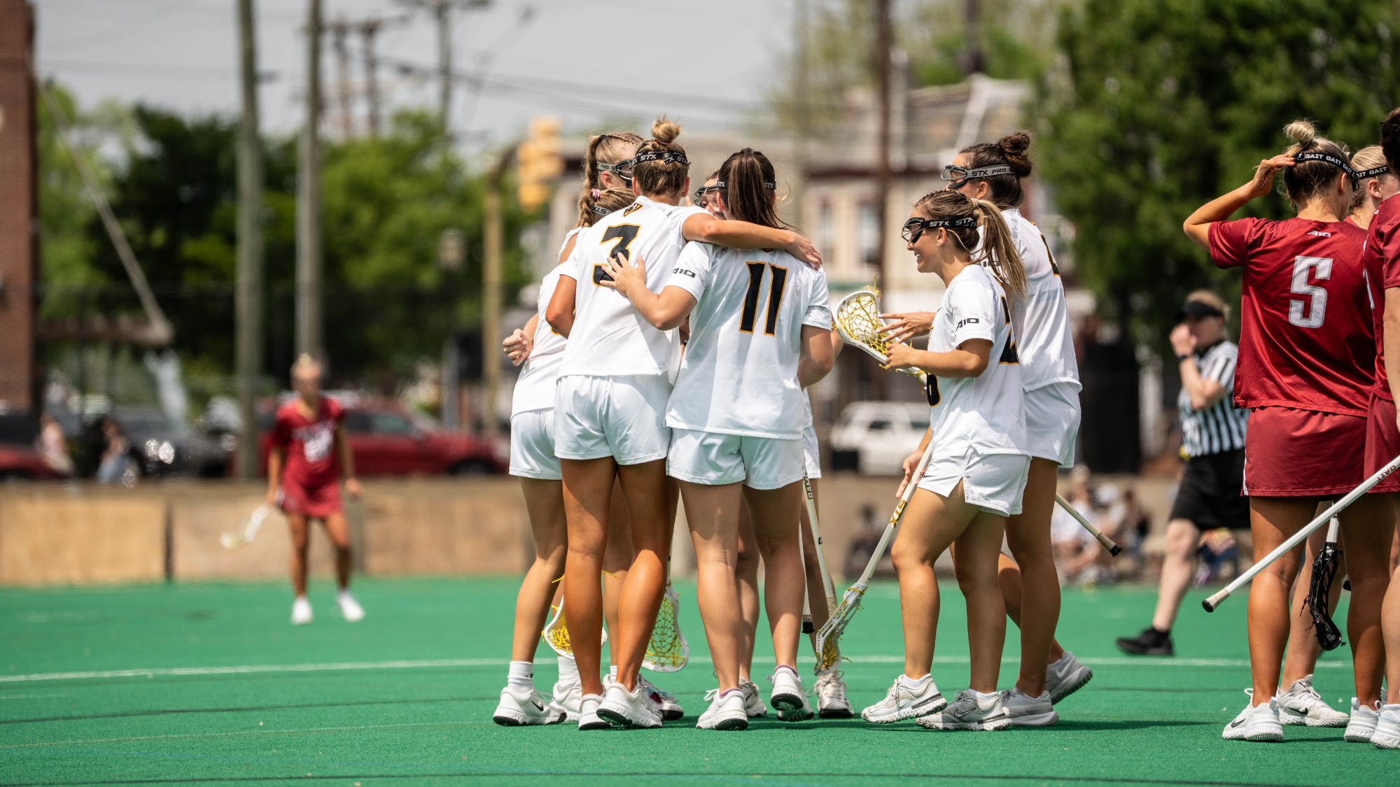 The VCU Lacrosse Team Huddles in celebration after scoring a goal against Saint Joseph's