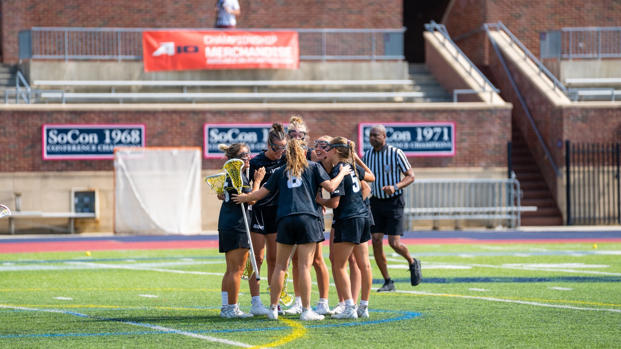 VCU Lacrosse team huddles wearing black jerseys during a 2025 A-10 First Round game against Davidson