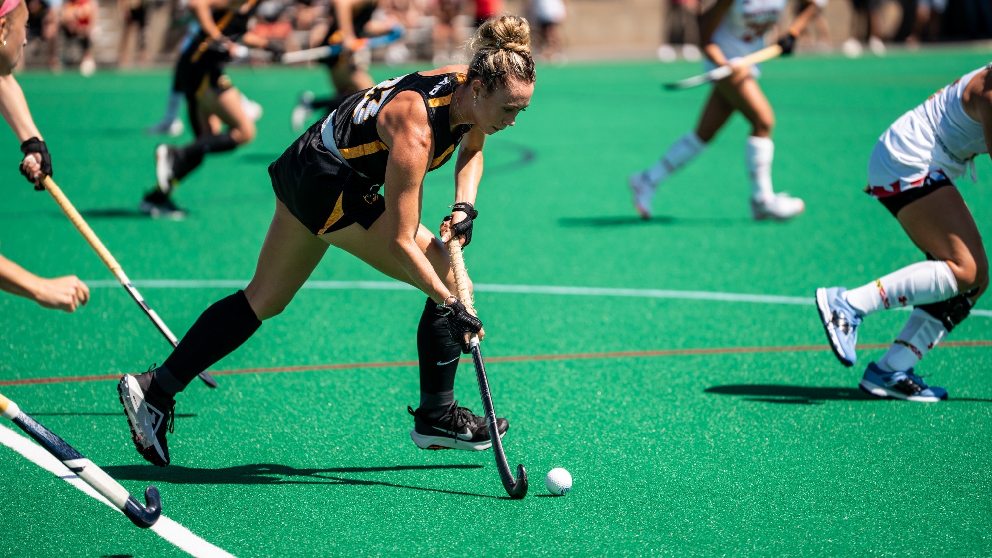 Morena Macera of VCU wearing a black #23 jersey dribbles against Maryland in an exhibition game