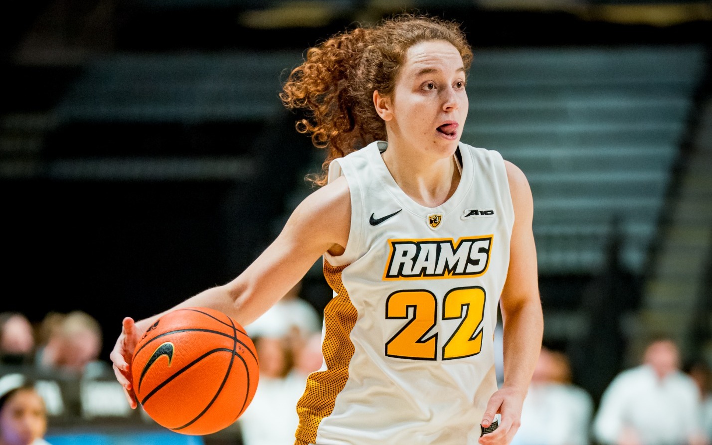 Laia Crespin of VCU wearing a white #22 jersey dribbles the ball unguarded against Duquesne