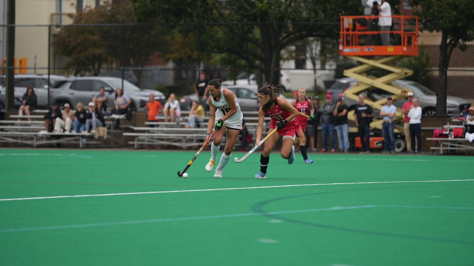 Hannah Zimmerman of VCU wearing a black #19 jersey dribbles the ball guarded by a Fairfield defender