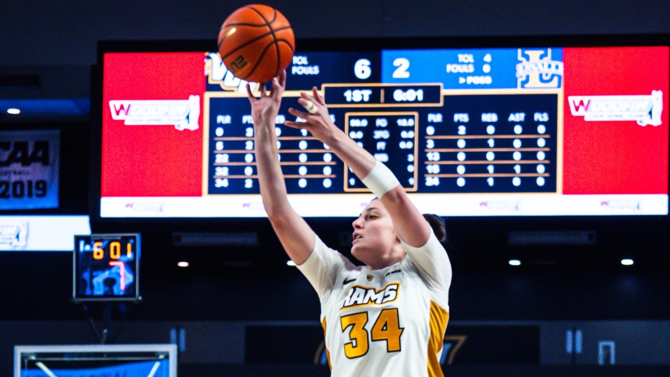 Katarina Knezevic of VCU wearing a white #34 jersey shoots the ball in a game against La Salle