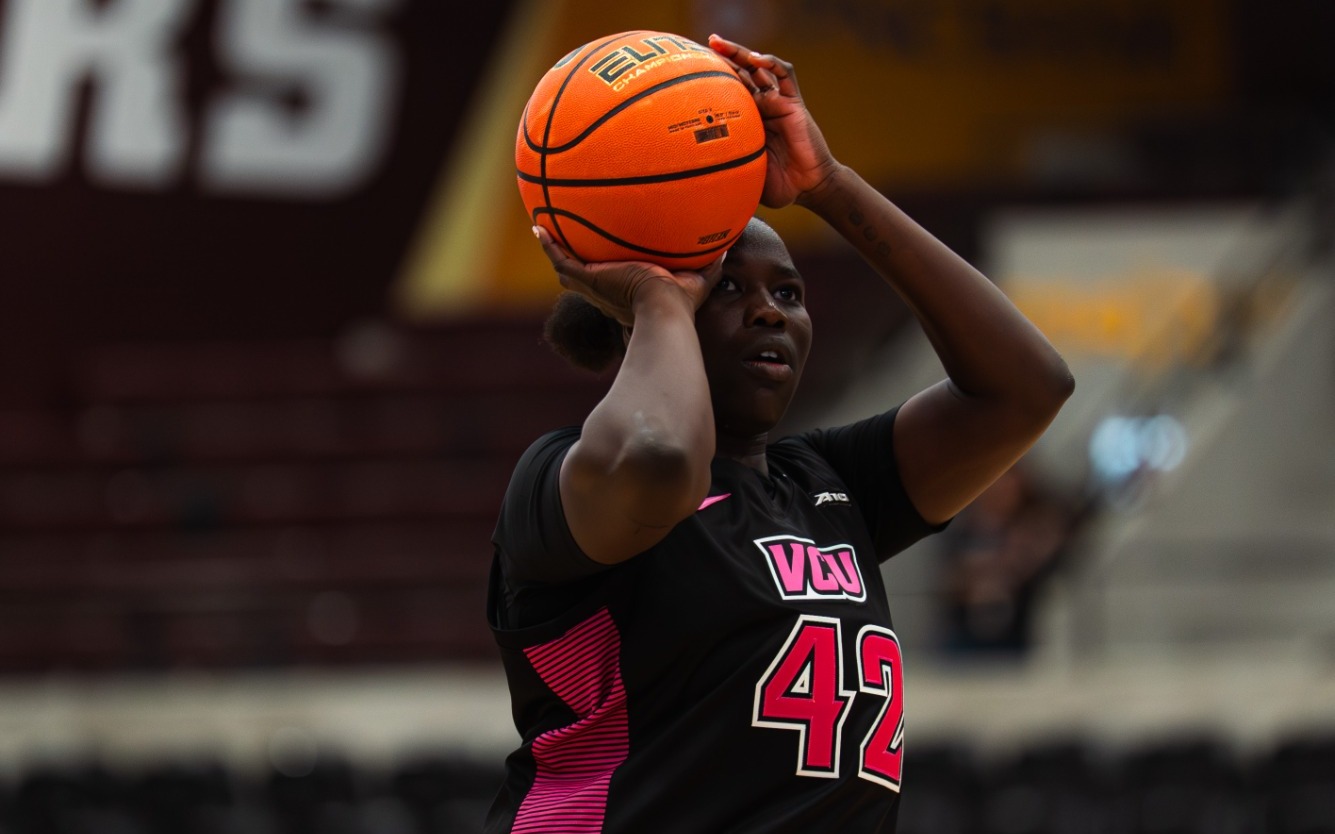 Lucy Ghaifan of VCU wearing a black and pink #42 jersey shoots a free throw in a game at Loyola Chicago