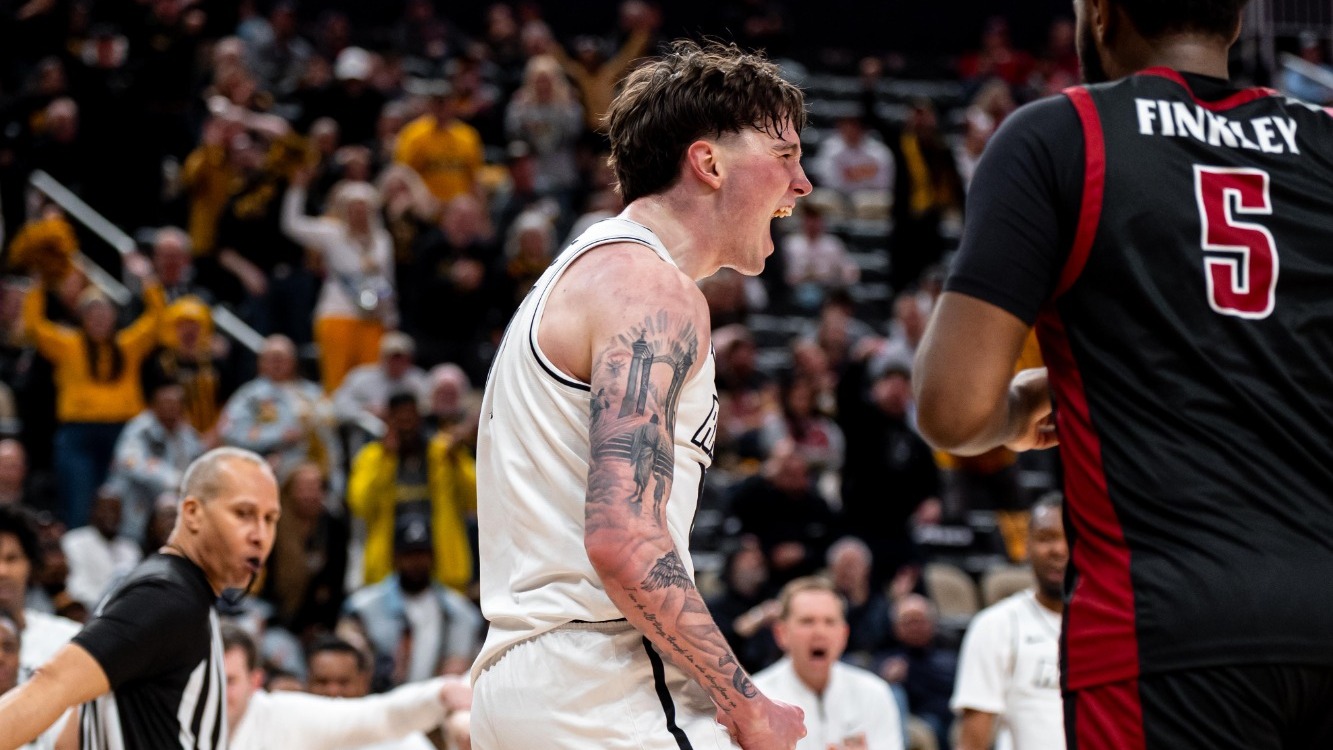 Lazar Djokovic screams in celebration wearing a white jersey in VCU's win over Saint Joseph's in the 2026 A-10 Semifinal