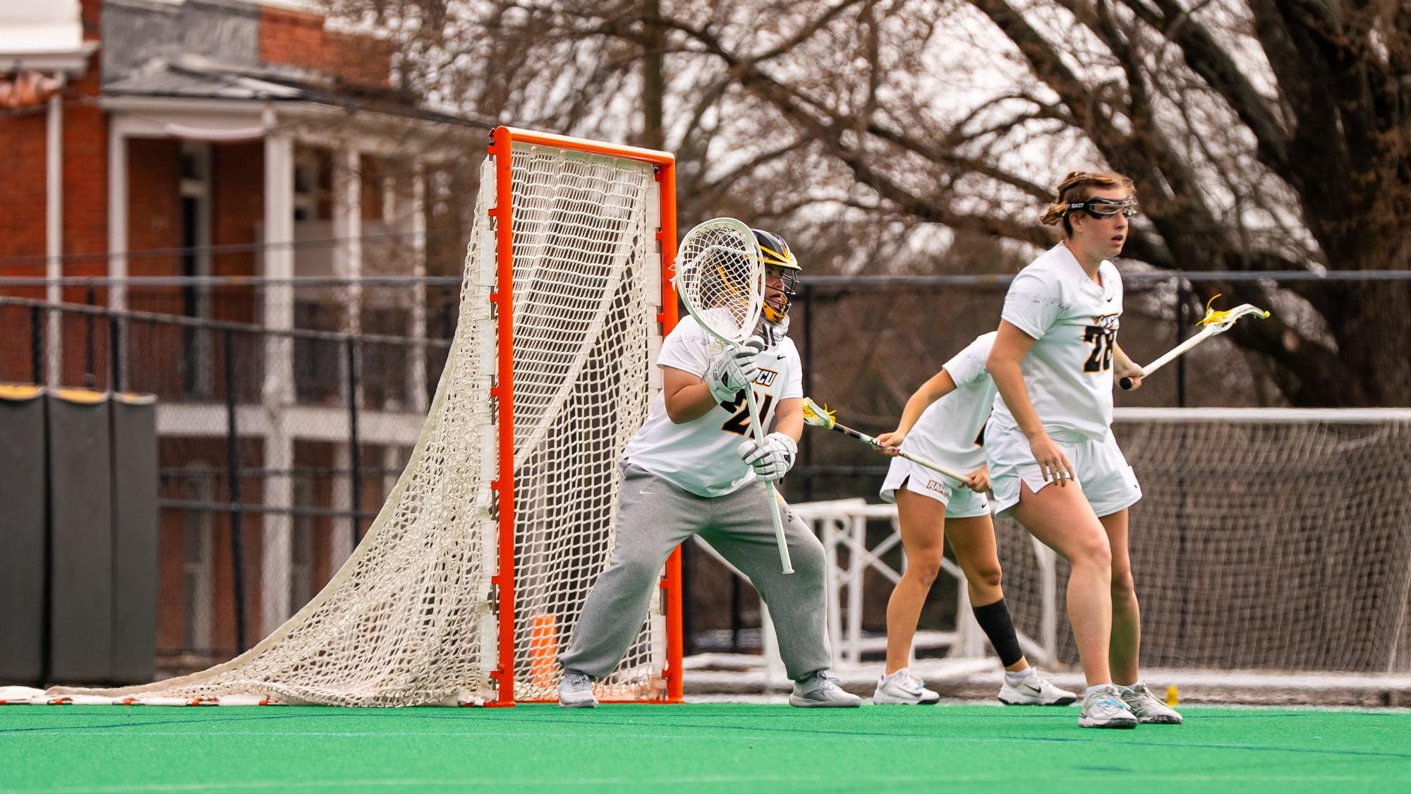 Goalkeeper Lu Doyen of VCU wearing a white #21 jersey stands ready to make a save in a game against Richmond