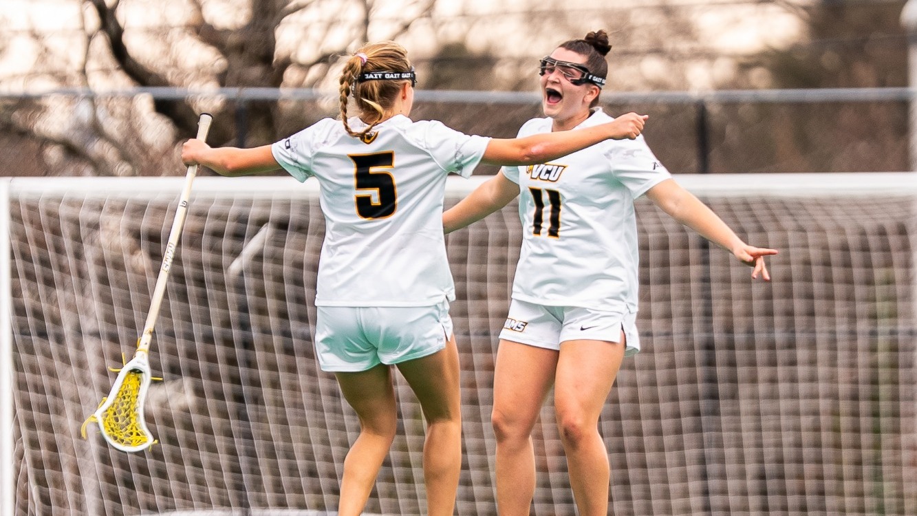 Rachel Koeneke and Kenson Epperly of VCU celebrate with outstretched arms after scoring a goal in VCU's win over William & Mary