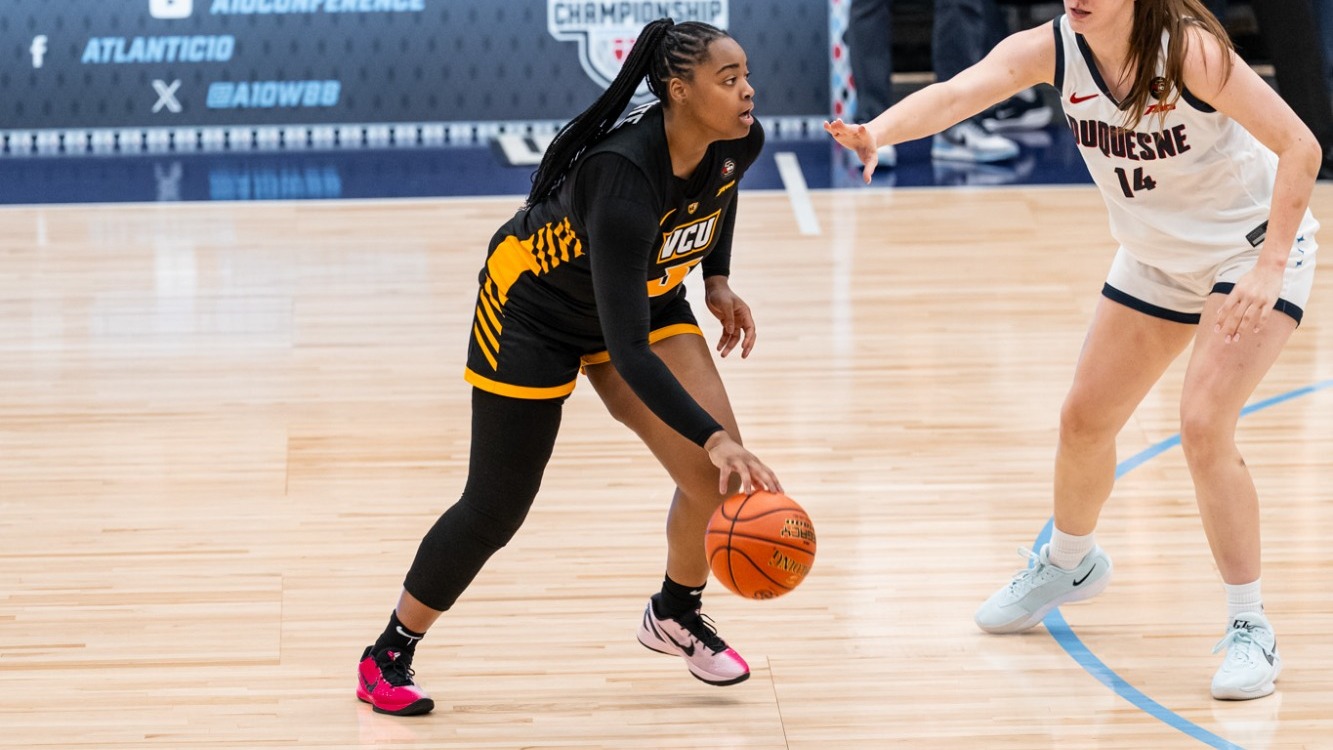 Makennah White of VCU wearing a black #5 jersey holds the ball while being guarded in a game against Duquesne in the 2026 A-10 First Round