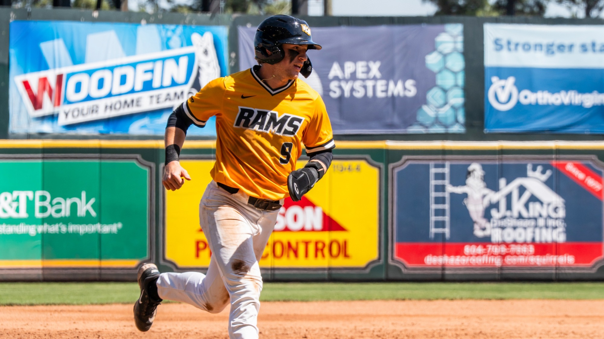 Trent Adelman rounds third base vs. St. Bonaventure