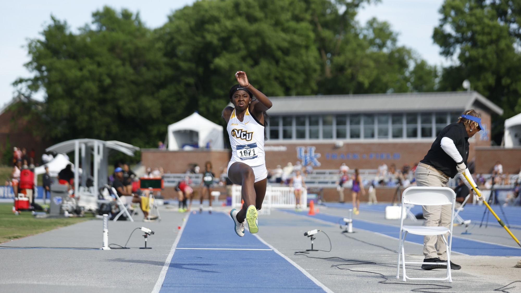 Sydney Carr of VCU wearing a white uniform jumps in the air as part of a triple jump attempt at the NCAA East First Round