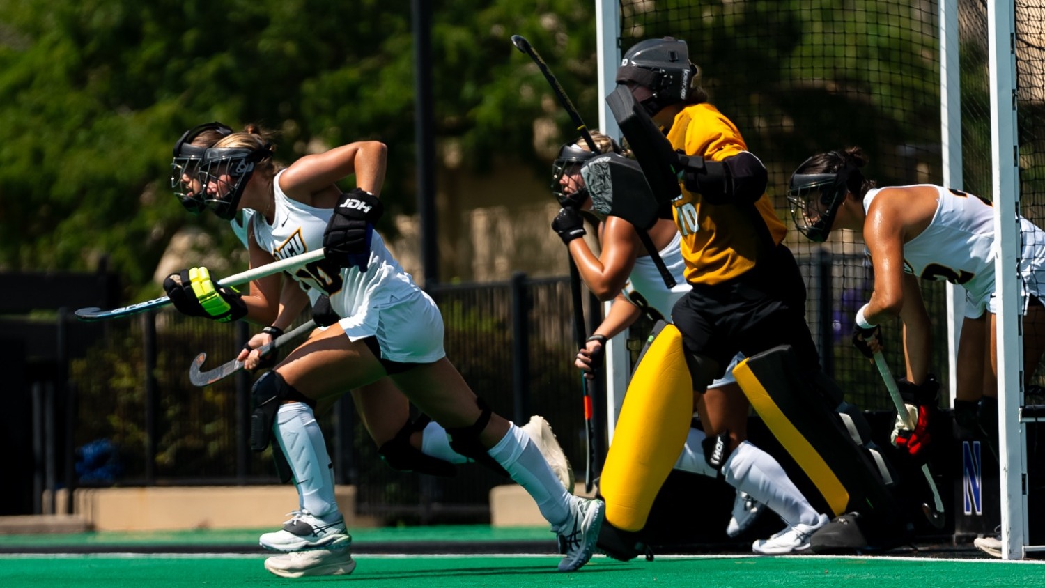 VCU's penalty corner defense unit runs out from the goal to defend a penalty corner in a game against Northwestern