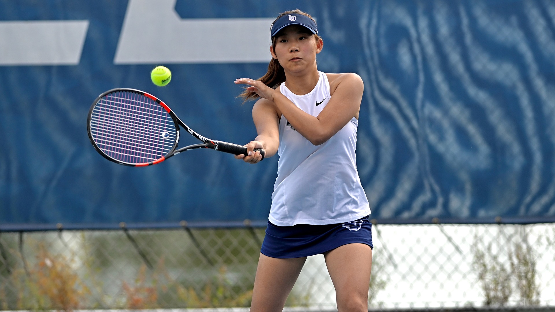 Lawrence women's tennis action Sky Shinohara
