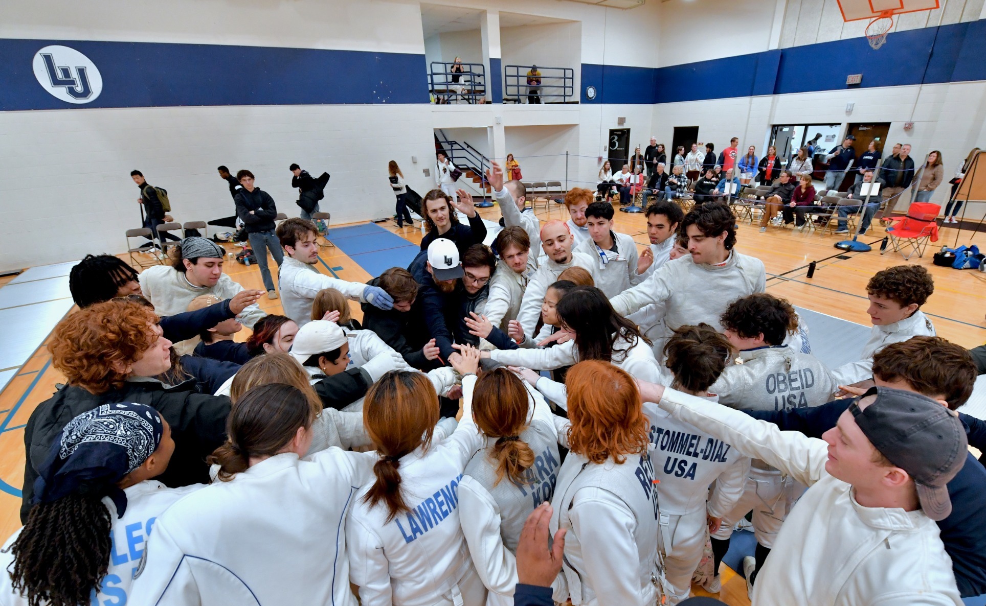 lawrence mens and womens fencing team huddle 
