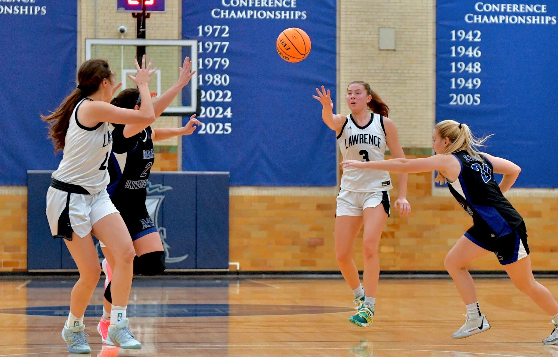action shot of lawrence wbb players sophie morey and olivia kesti