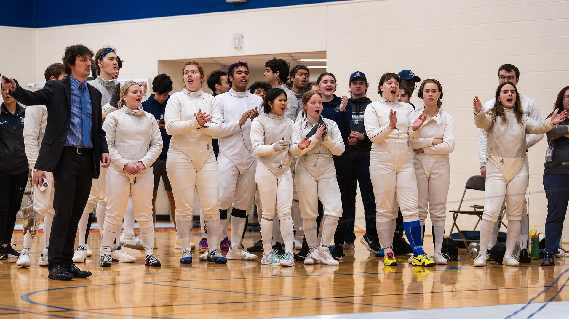 Women's fencing group cheering on others