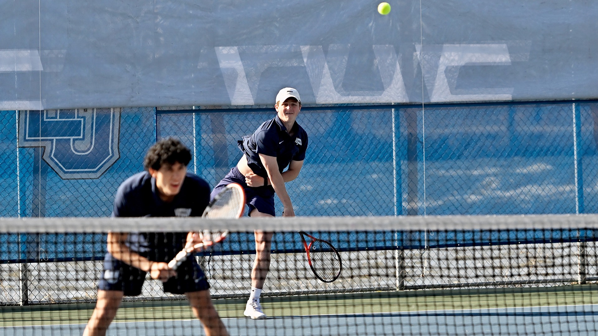 Will Phillips action Lawrence men's tennis