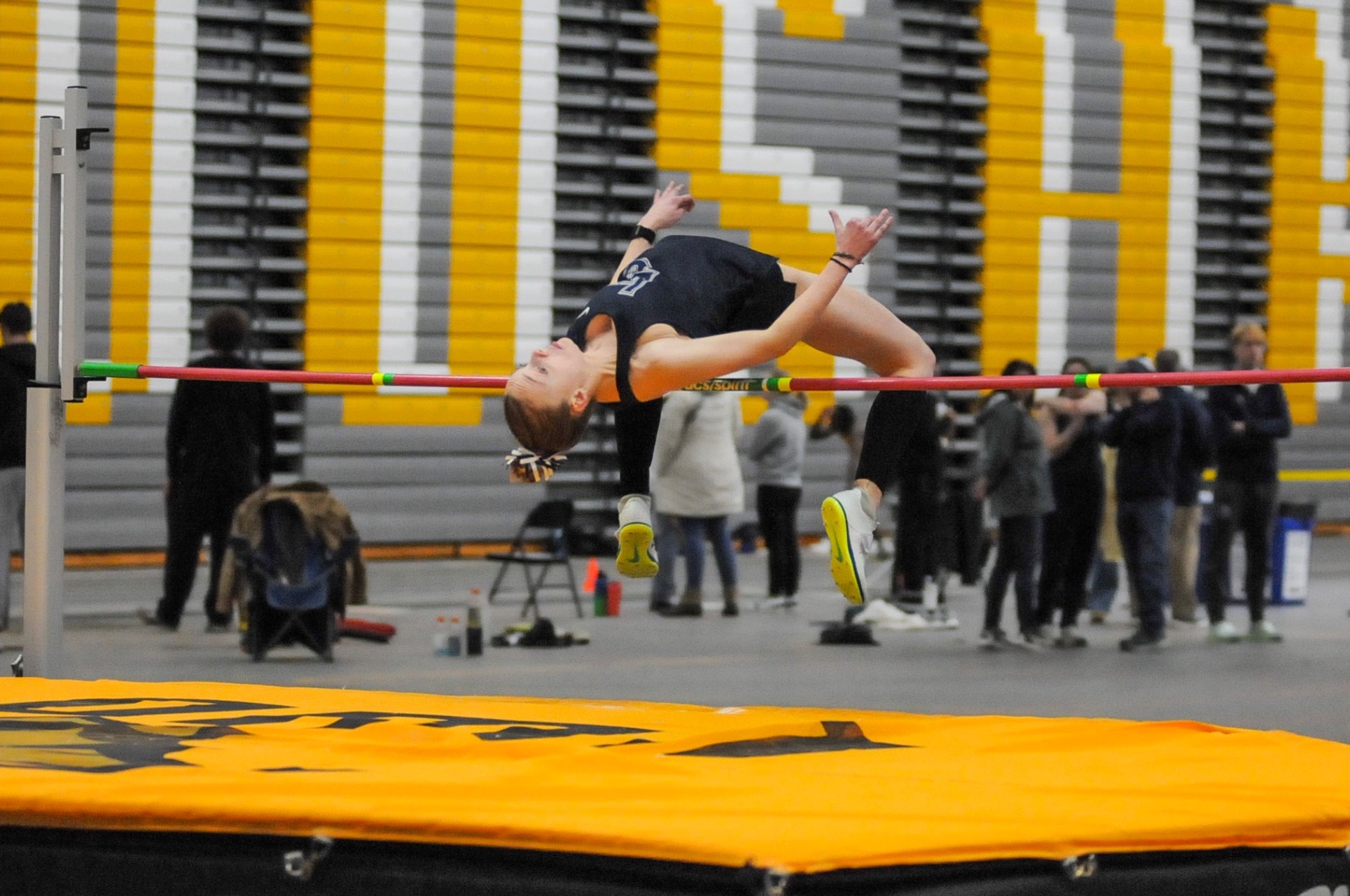 action shot of womens track high jumper 