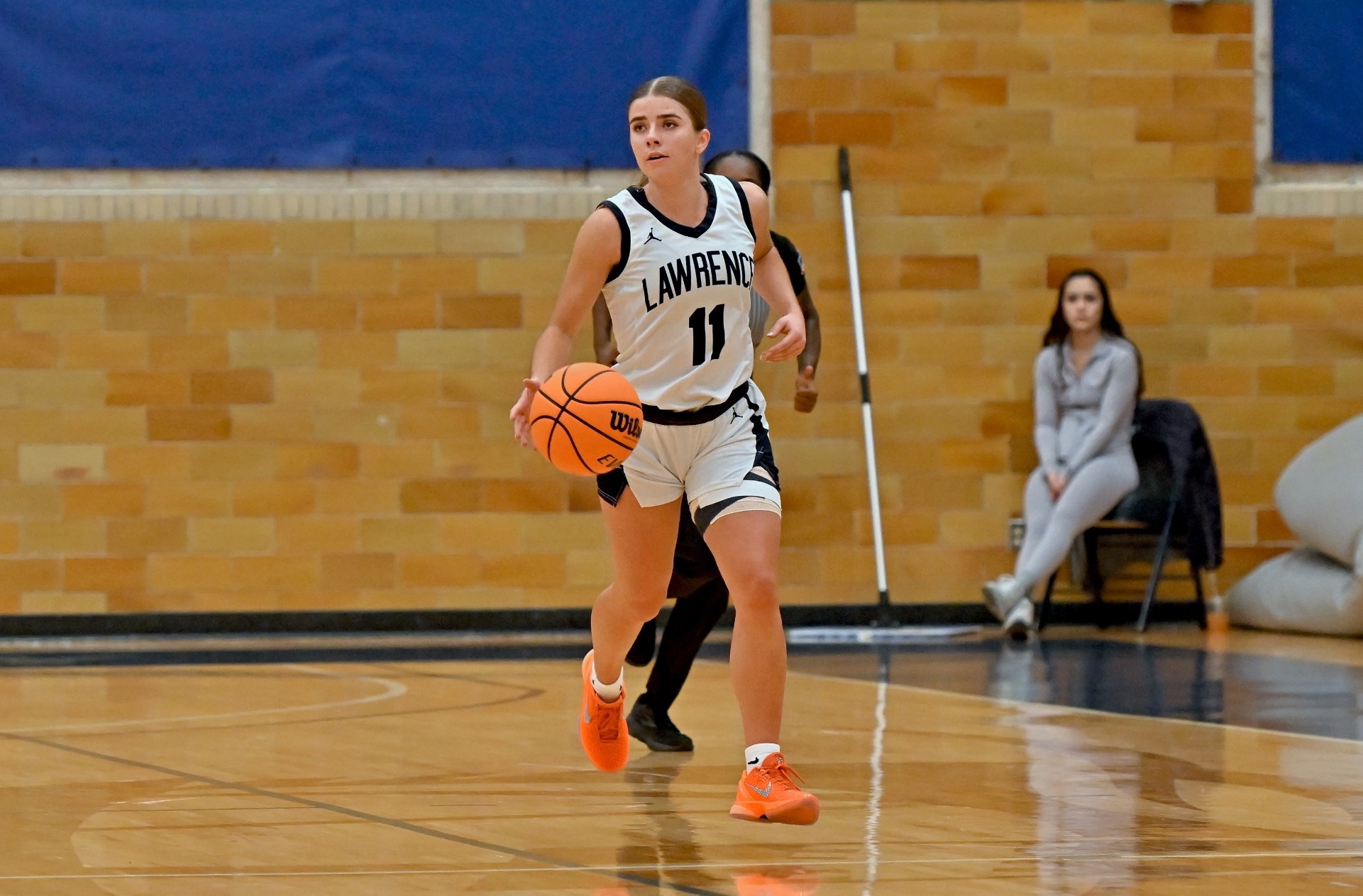action shot of charolette brennan from womens basketball