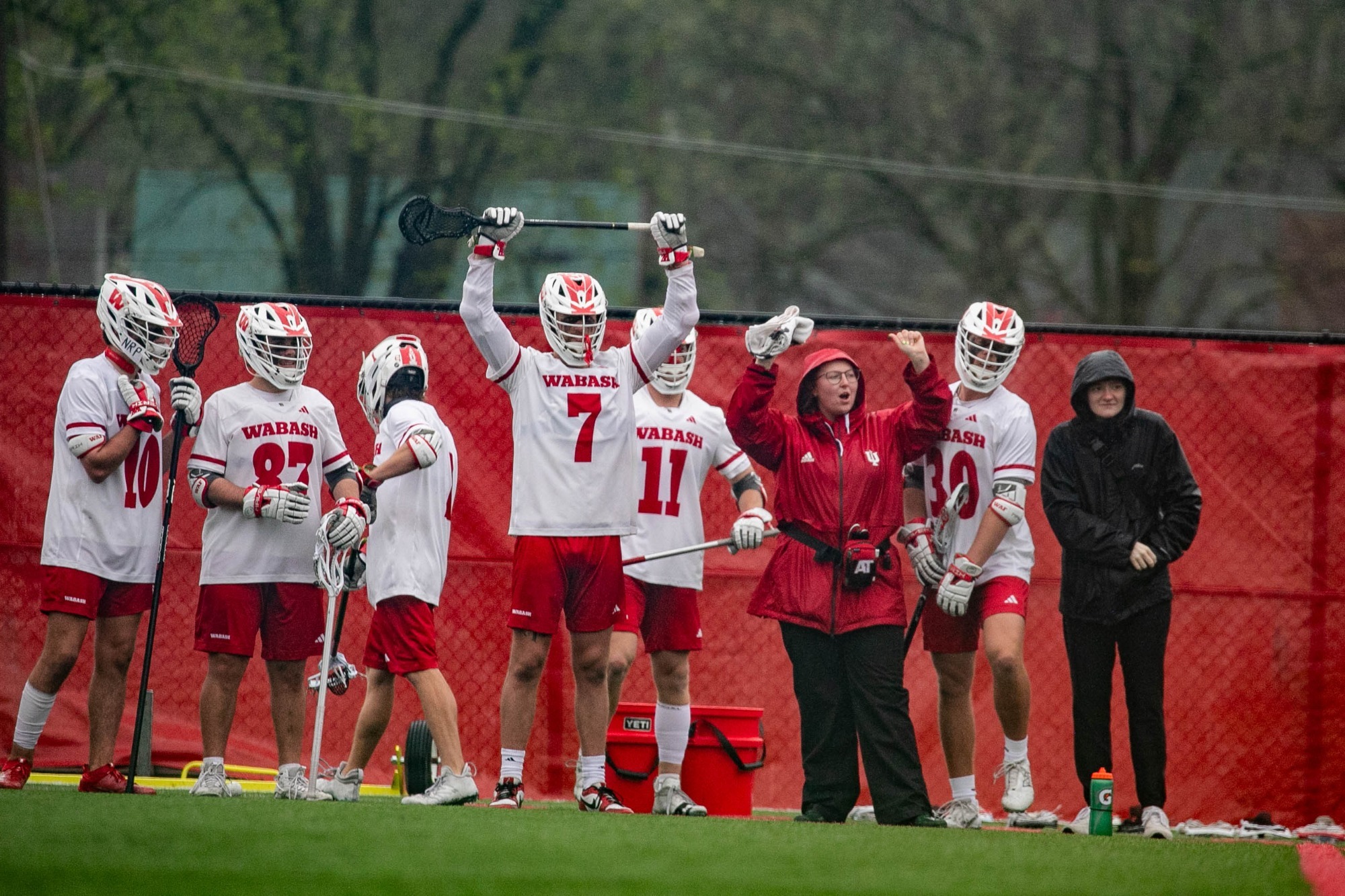 Wabash College lacrosse players celebrate a goal against Hiram