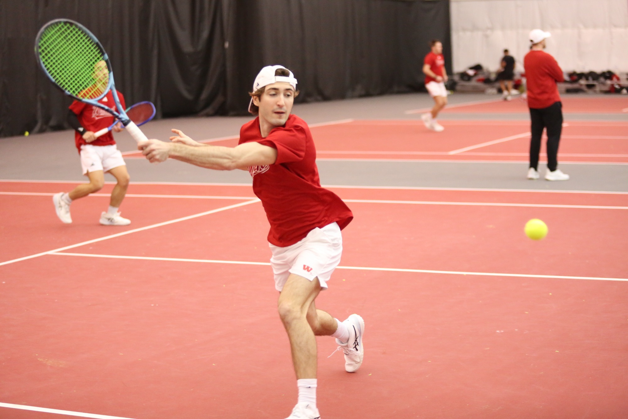 A Wabash tennis player returns a shot