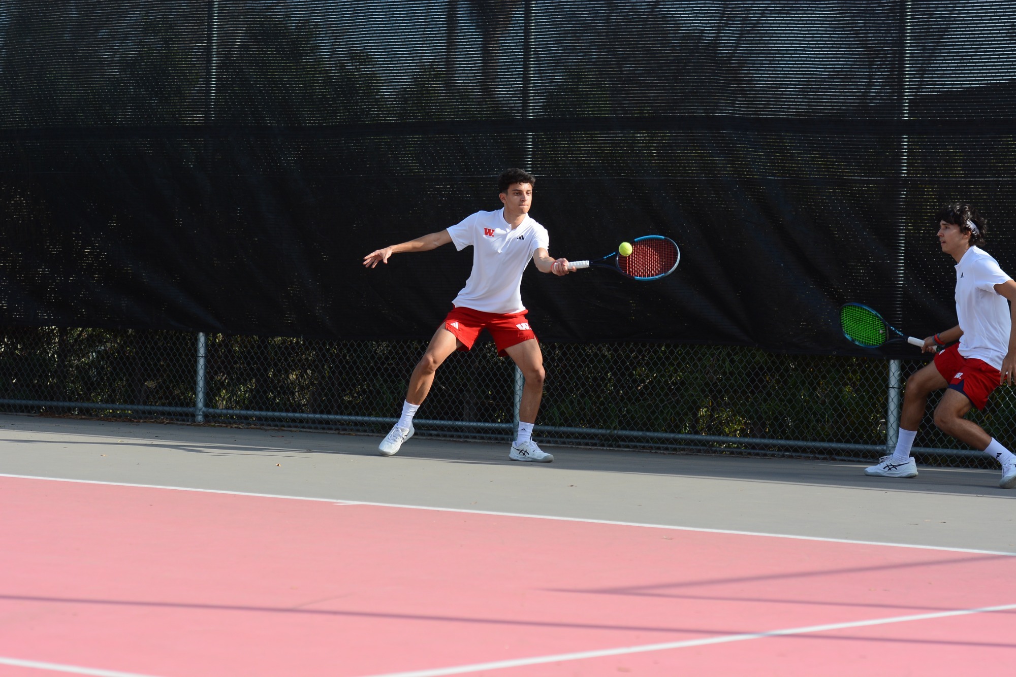 Rafael Rin returns a shot in doubles play for Wabash.