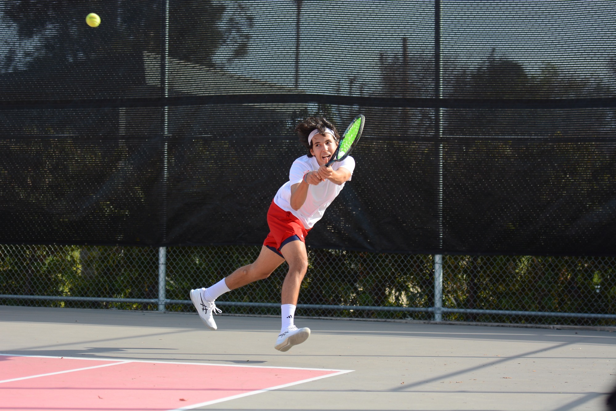 Wabash tennis player returns a shot in a match in California