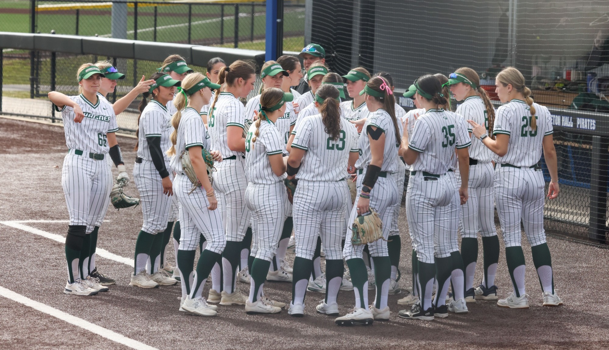Softball huddle vs. Seton Hall