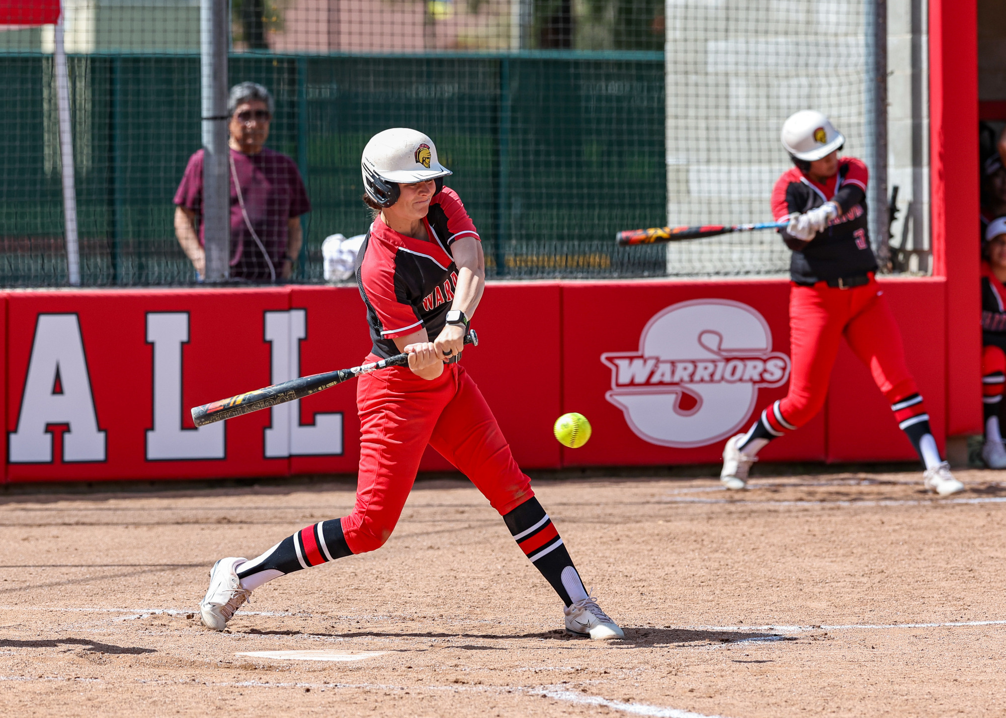 Karli DalBianco puts everything into her swing as the ball crosses the plate.