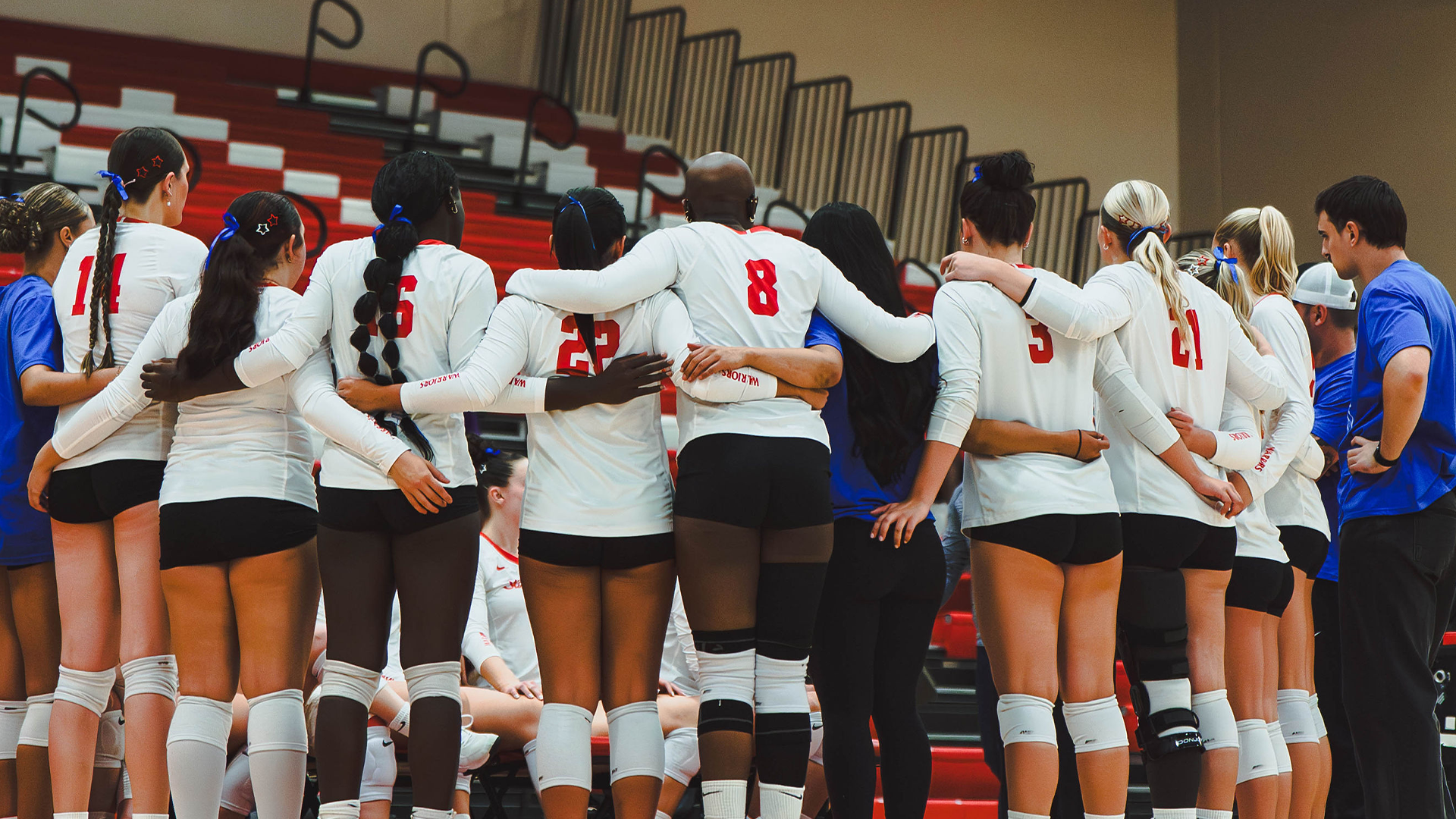 Photo of Warrior Volleyball in a Huddle