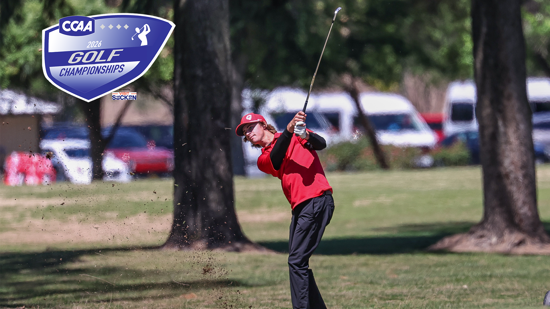 Riley Kirk of Stan State follows through on a golf shot at a recent tournament, striking the ball from the fairway with dirt flying on contact.