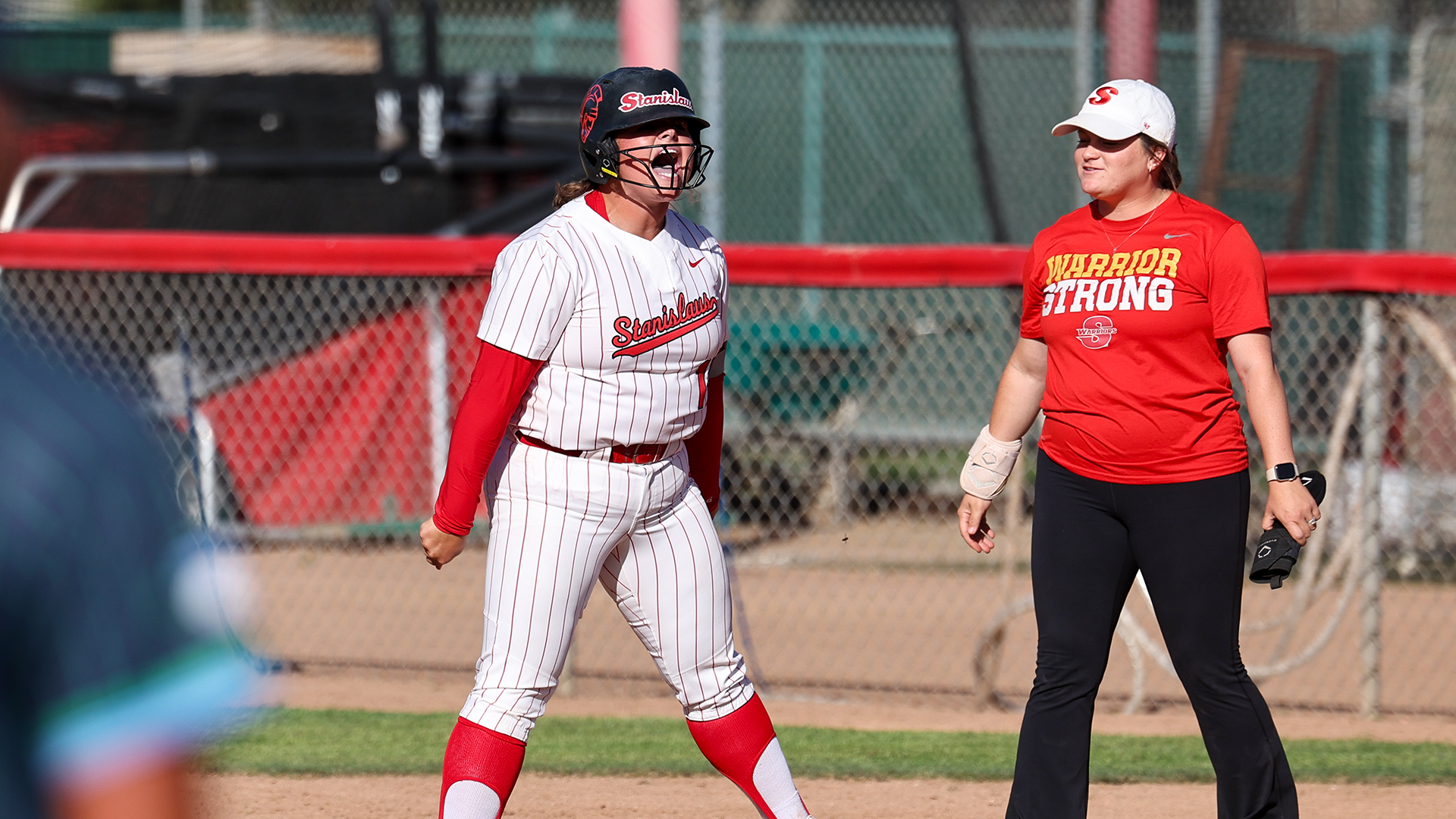 Nat Camarena fires up with an emotional celebration on the field, shouting with intensity after a big moment while a teammate looks on nearby.