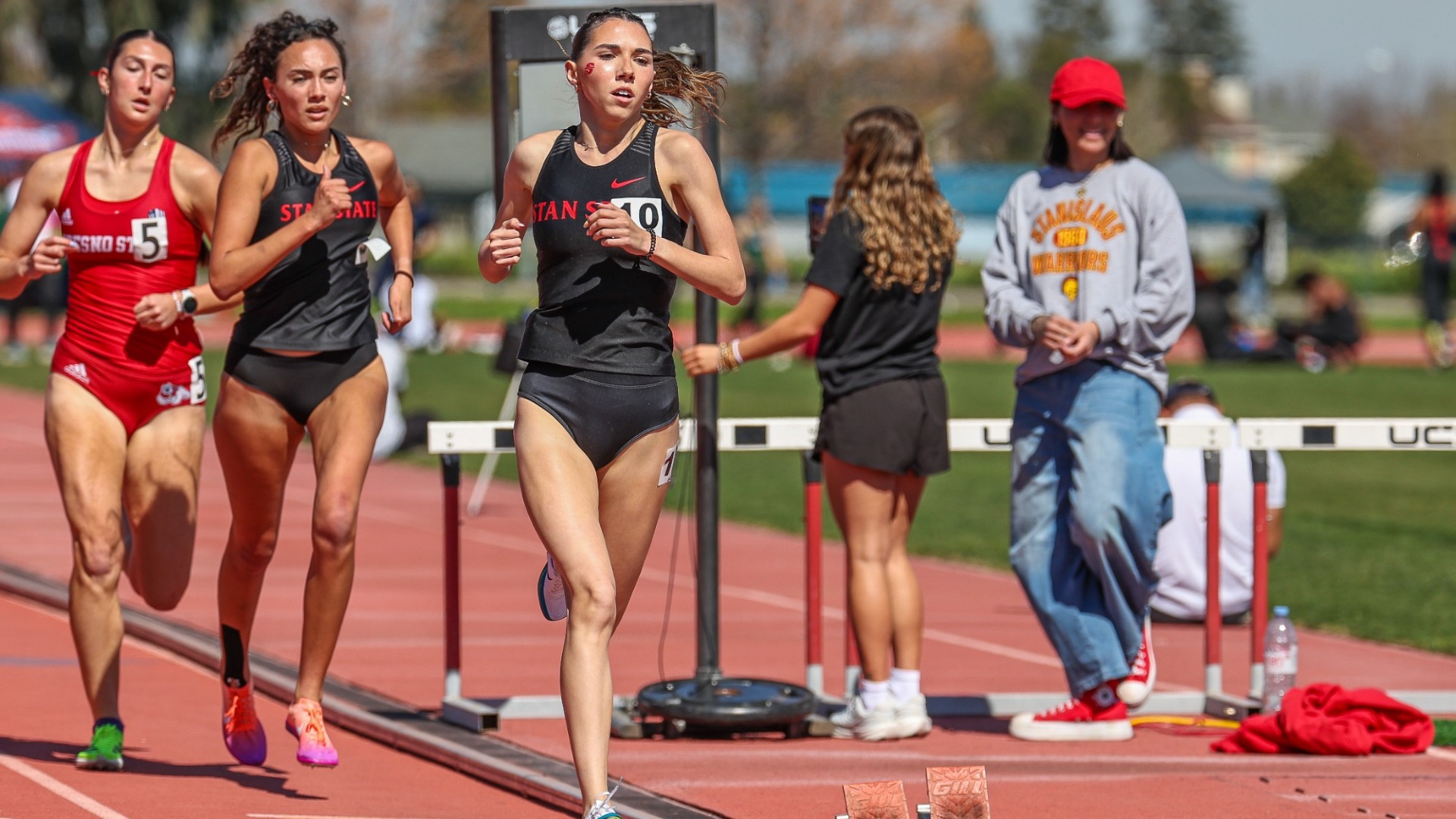 Megan Silva runs the track, and is mid-stride.