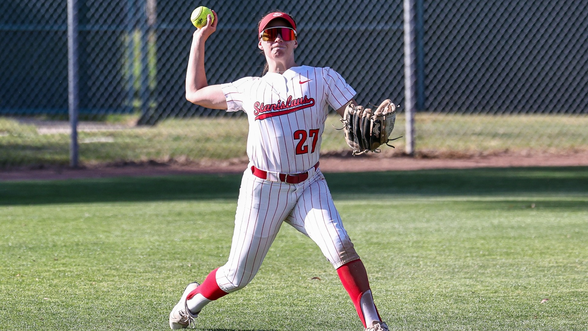 Maggie Pyke in the outfield throwing the balls.
