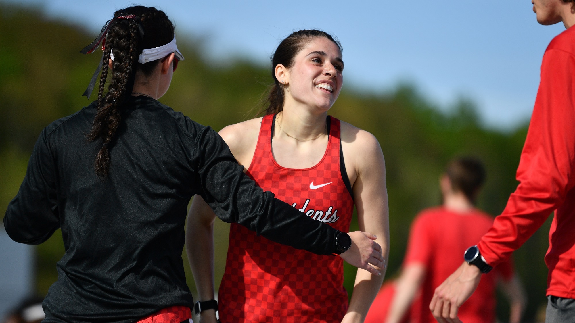 Jadyn Hartner is congratulated by teammates after winning an event at the 2024 PAC Championships