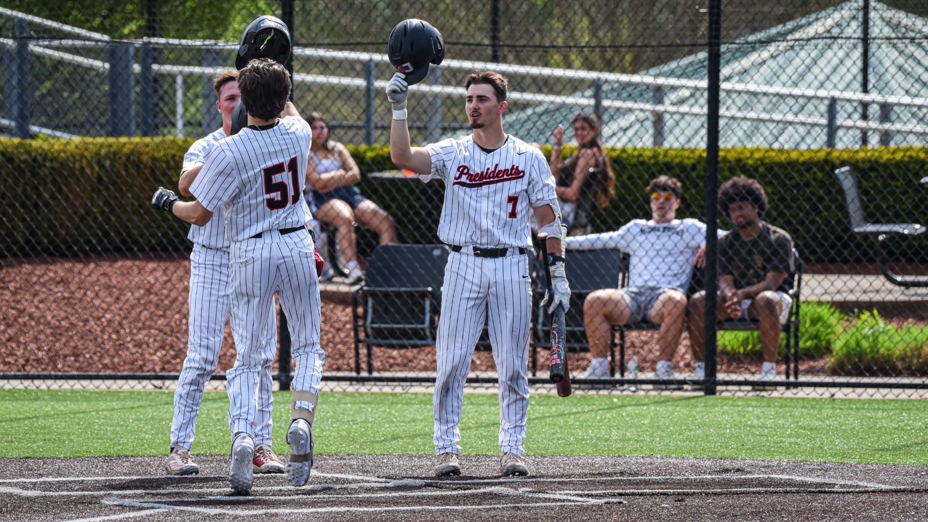 Luke Alvarez celebrating teammates homer on senior day