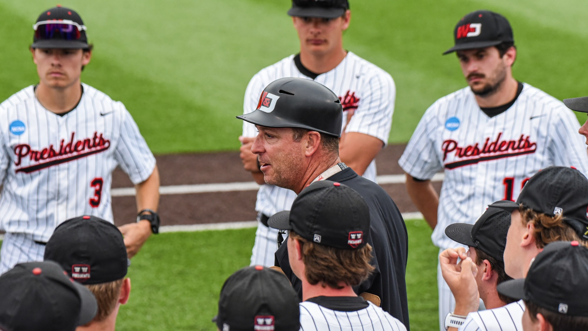 Coach Mountain addresses the 2026 team during the NCAA Regionals vs. Bridgewater