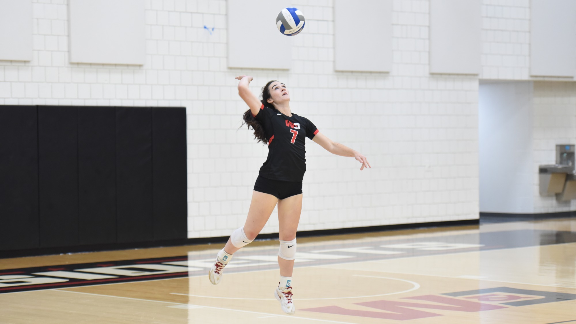 Brielle Moorhouse serving against Muskingum in 2026 match