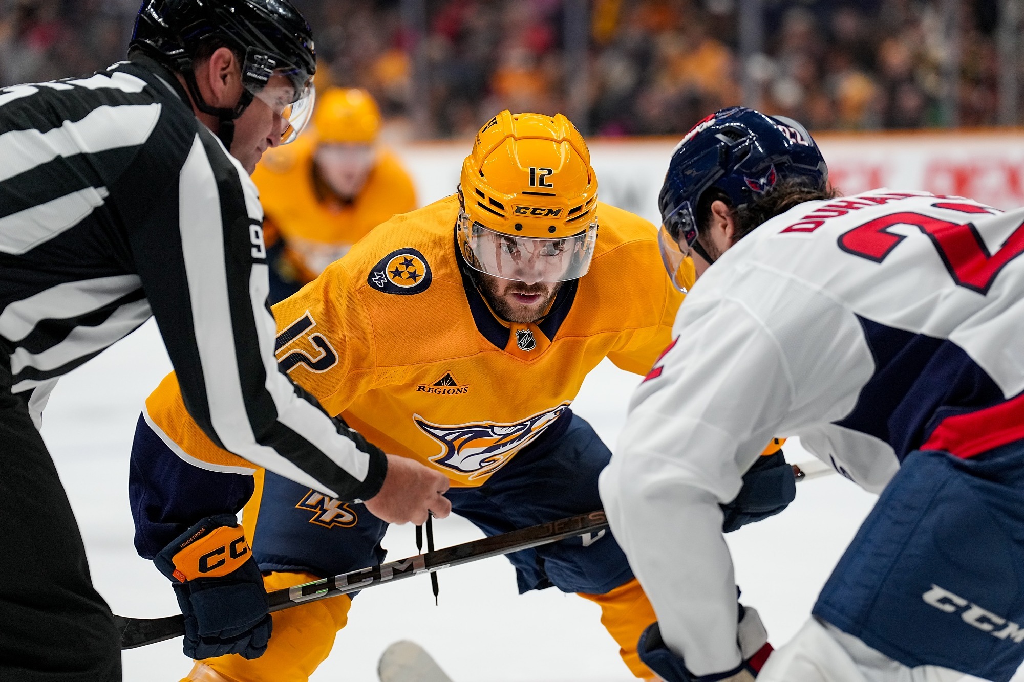 NASHVILLE, TENNESSEE - JANUARY 11: Vinnie Hinostroza #12 of the Nashville Predators faces off against the Washington Capitals during an NHL game at Bridgestone Arena on January 11, 2025 in Nashville, Tennessee. (Photo by John Russell/NHLI via Getty Images)